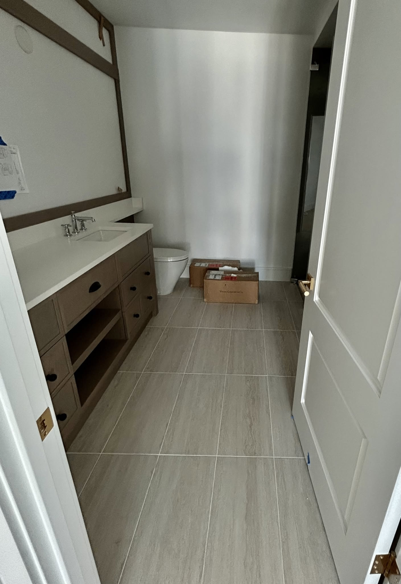 Guest bath with light wood-look plank tile flooring